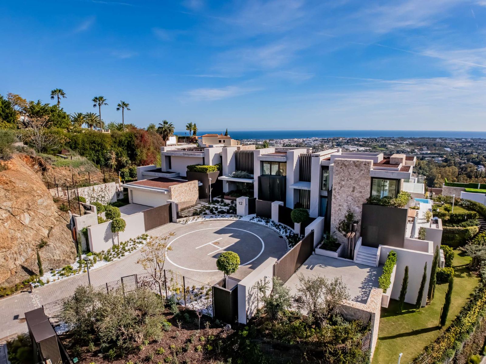Aerial view of The Hills Nº 12 luxury villa and private helipad above Marbella