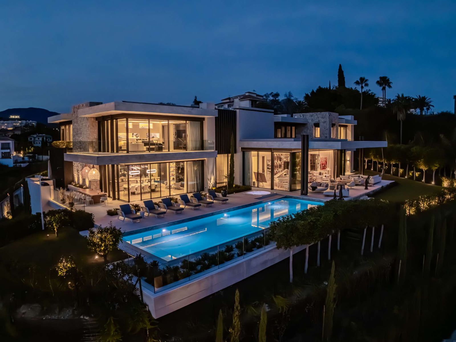 The Hills Nº 12 villa and infinity pool illuminated at dusk