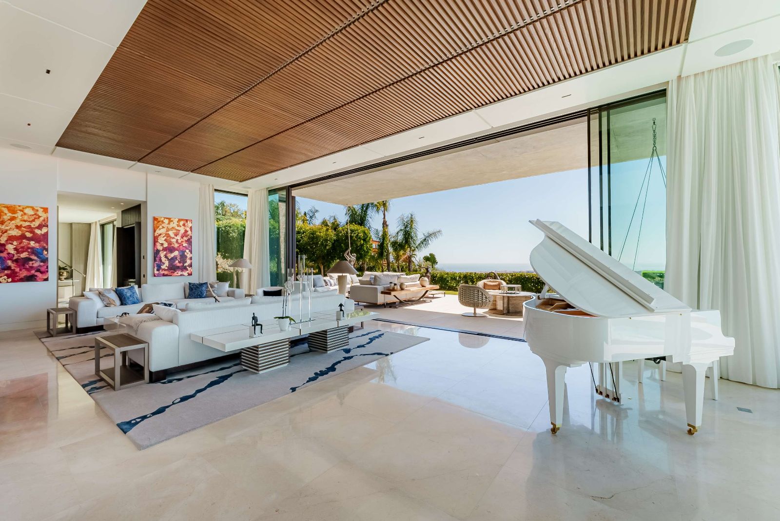 Living room with white grand piano opening to the terrace and sea view, The Hills Nº 12
